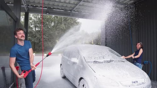 Woman and Man Washing Car Together