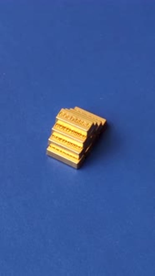 Gold Bullion Bars Stacked on Blue Background