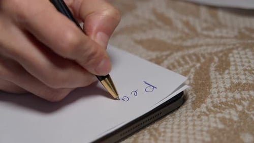 Closeup Female Hand Handwriting Peace War Love on White Paper with Blue Pen Closeup Unrecognizable