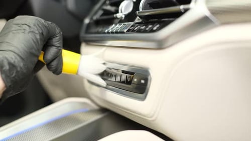 A Employee of a Car Wash Washes the Car Inside He Wipes the Instrument Panel with a Special Brush