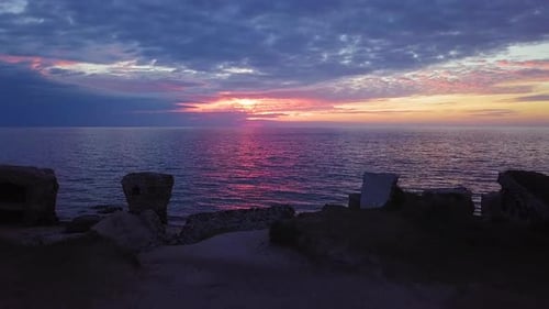 Beautiful aerial vibrant high contrast sunset over calm Baltic sea, dark storm clouds at horizon, Ka