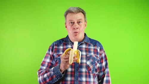 Man Eating Banana on Green Screen Background