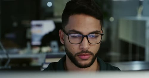 4k video footage of a young businessman working late in an office at work