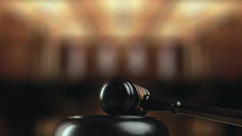 Judge is Hitting Gavel Off a Block in Courtroom