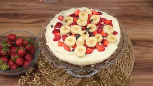 Decorating Sweet Cake with Fresh Fruit and Chocolate Chips