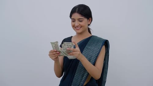 Woman Counts Cash in a Sari