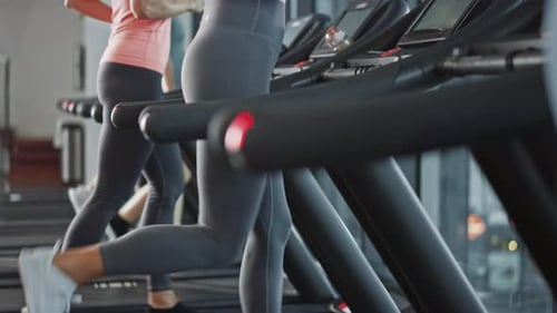 Beautiful Athletic Sports Woman Wearing Wireless Headphones, Listens to a Podcast or Sport Music Pl