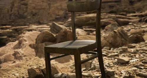 Chair Placed in a Rocky Desert Landscape During Bright Daylight