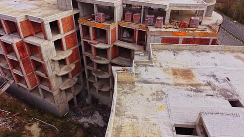 Construction site of a large unfinished building in an urban area