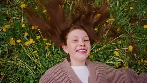 Teenage Girl Smiling in a Field of Dandelions
