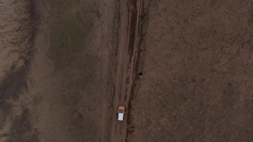 Aerial Birds Eye Overhead Top Down View of Car Driving in Countryside