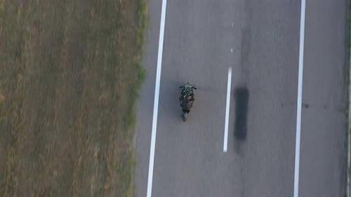 Top View to Biker Driving Motorbike During Road Trip