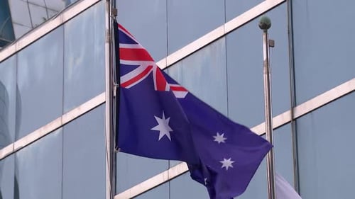 Australian Flag Waving in the Wind in City