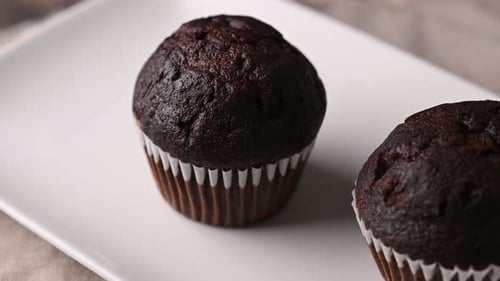 Delicious Chocolate Cupcakes on a White Plate Dolly Shot
