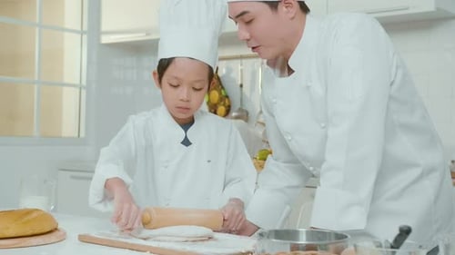 Boy and Man Baking Together in a Kitchen