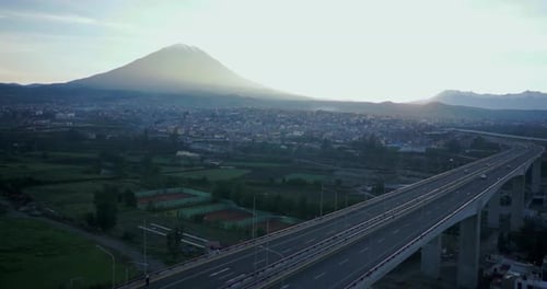 Empty road in the jungle with a landscape of trees and vegetation behind during a sunrise. 4K