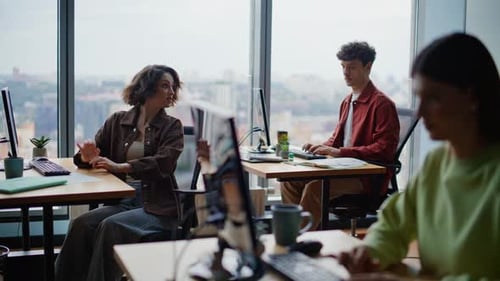 Young Programmers Coding Computers Sitting Together at Spacious Coworking Zone