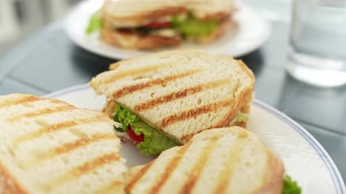 Delicious toast sandwiches with vegetables on white plates, close up