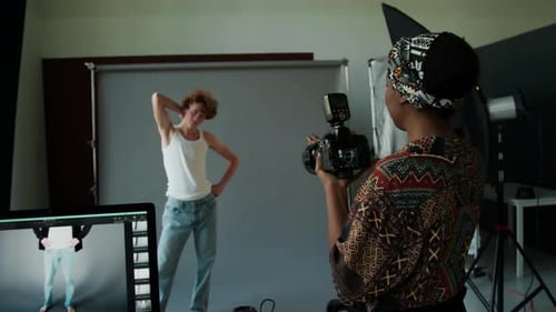 Professional Photographer Taking Pictures of Model in Studio