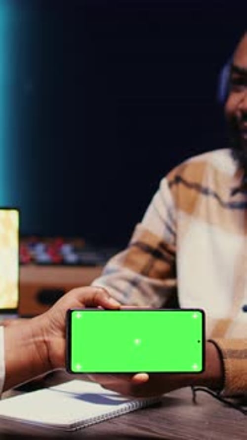 Vertical Video Guest Reacting to Videos on Mockup Mobile Phone During Online Comedy Show