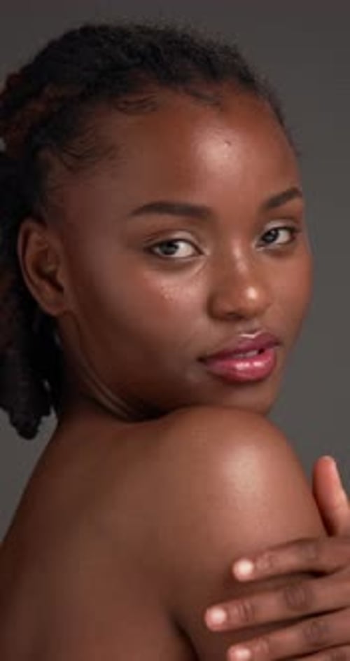 Skincare, smile and face of black woman in studio with natural, hydration and beauty results