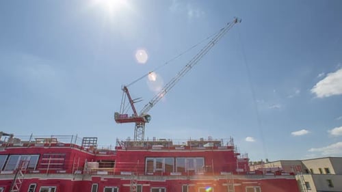 Construction Crane Lifting Materials on Sunny Day