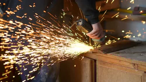Grinding Metal Causes Sparks in Workshop