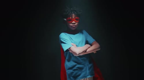 Studio Shot of African American Little Boy Dressed as Superhero