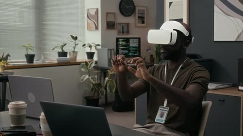 Man Using VR Headset in Modern Office Setting