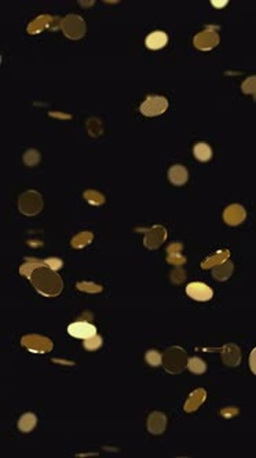 Golden coins falling on the black background.