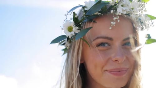 Smiling Woman Wearing Flower Crown in Bright Sunlight