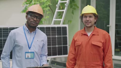 Portrait of Diverse Engineer and Worker by Solar Panel Outdoors