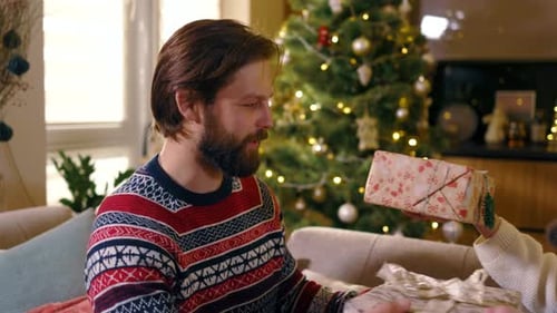 Couple Exchanges Loving Christmas Gifts at Home