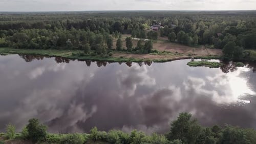 Aerial view of the river in the forest. Mist over the river and beautiful reflection of trees in wat