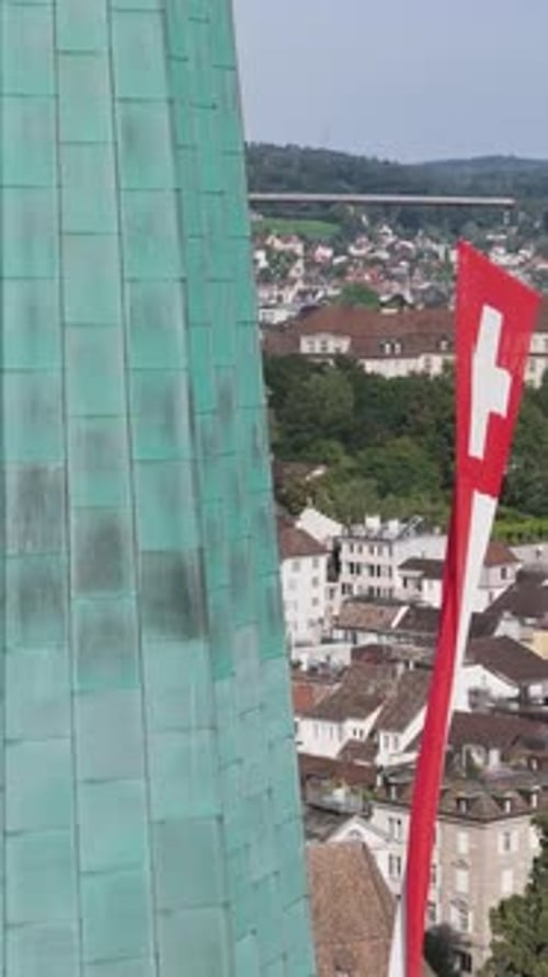 Aerial video of the Swiss flag at the Grossmunster church and the city in the background.