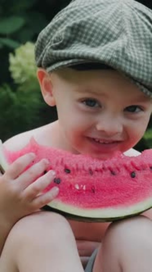 Child Enjoys Watermelon Snack Outdoors in Summer