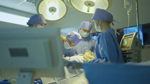 Doctor and nurse team help to treat patient lie on bed in operation of the hospital and they work