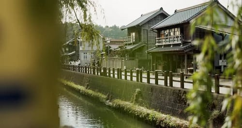 Buildings, nature and Japanese architecture by a canal for landscape, travel or village culture