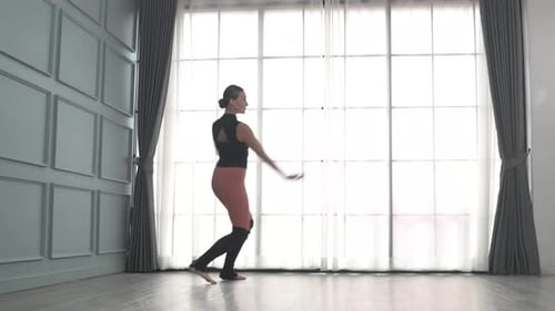 Friends practice ballet dance at studio.