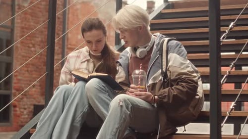 Couple of Students Studying Together on Stairs Outdoors