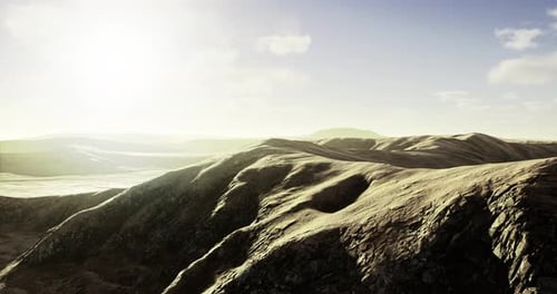 Flying Over Arid Mountain Range on Sunny Day