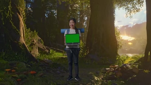 Female Hiker Smiling And Showing Mock Up Green Screen Laptop While Exploring Nature