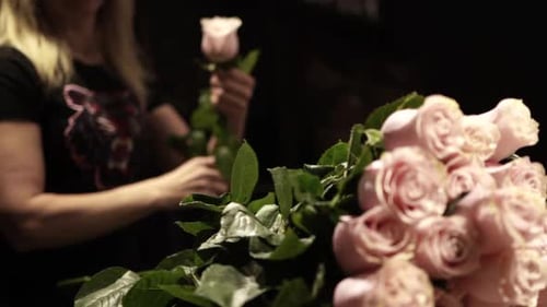 Florist making bouquet of flowers in flower shop in Lviv