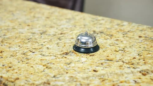 Bell on reception at the hotel to call the administrator. Beautiful blurred background.