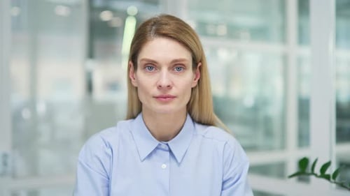 Webcam view. Close up. Businesswoman watching video call training looking at camera while sitting