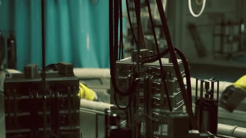 Atmospheric Lighting Highlights Repair Area with Worn Panels and Hanging Cables