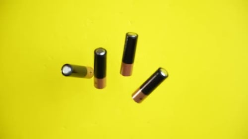 Batteries on Yellow Surface Zoom Out