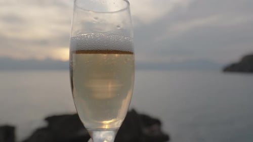 Champagne Bubbles, Sunrays Reflect in Glass, Close-Up Slow Motion, Date by Sea.