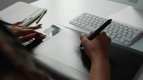 Hands Working on Graphics Tablet with Stylus