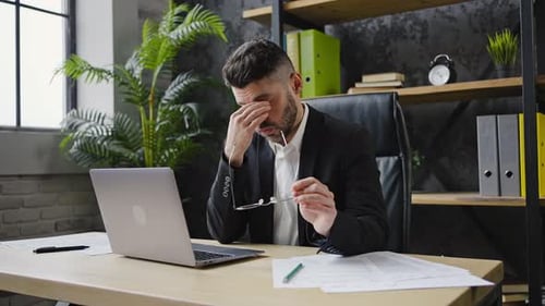 Young Office Worker Suffers From Headache and Sore Eyes